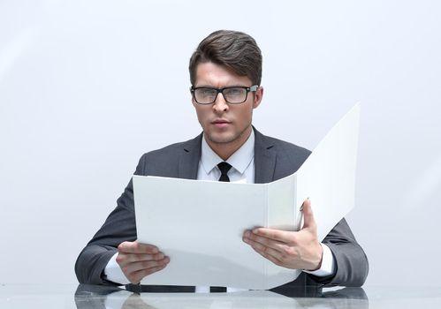 close up. businessman reading documents sitting at his Desk.business concept