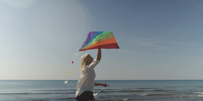 Beautiful Young Woman Holding A Kite at Beach on autumn day