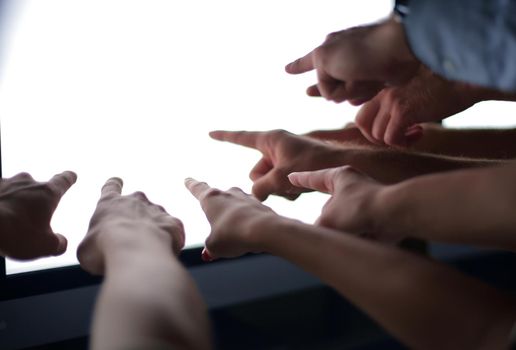 close up. business team pointing at computer monitor. concept of good results