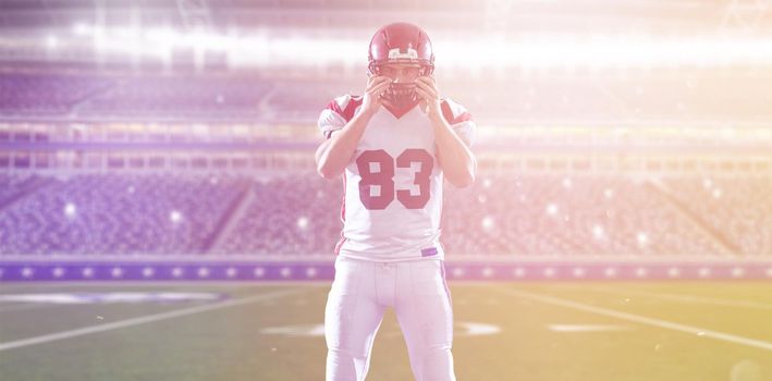 American Football Player isolated on big modern stadium field with lights and flares