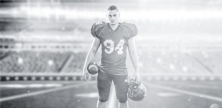 American Football Player isolated on big modern stadium field with lights and flares