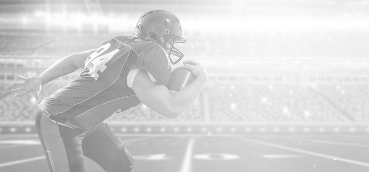 American football Player running with the ball isolated on big modern stadium field with lights and flares