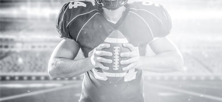 Closeup Portrait of a strong muscular American Football Player on big modern stadium field with lights and flares