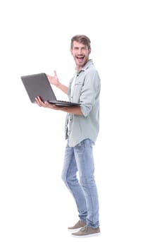 in full growth.happy young man with laptop .isolated on white background