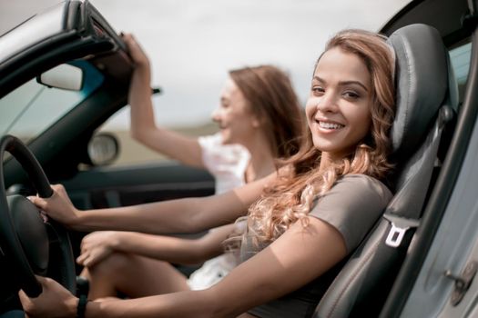 modern young woman driving a convertible.a great day for a trip