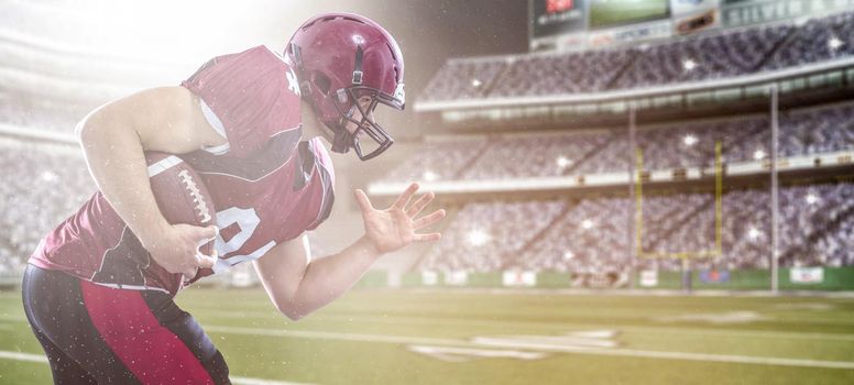 American football Player running with the ball isolated on big modern stadium field with lights and flares