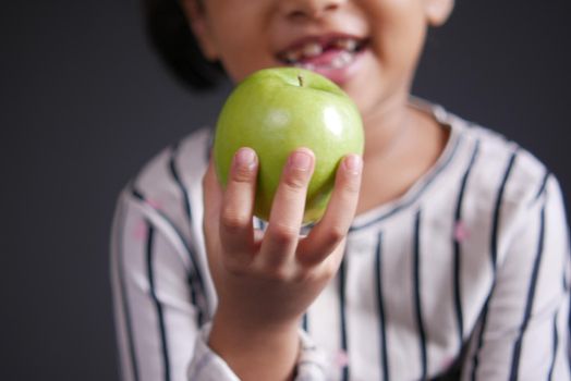 child girl hand hold a apple selective focus .