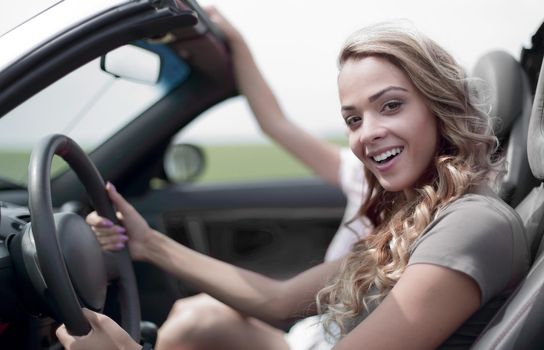 modern young woman driving a convertible.a great day for a trip