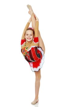 A girl gymnast balances on one leg.The concept of childhood, sport, a healthy lifestyle. Isolated on white background.