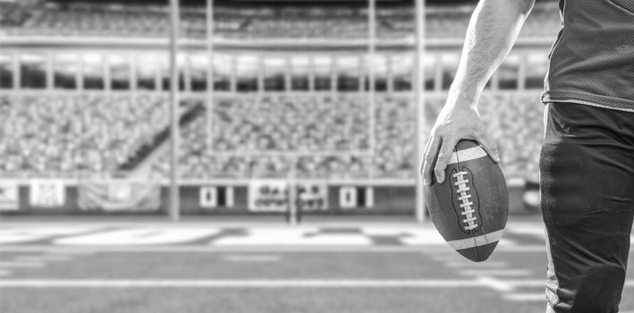 Closeup Portrait of a strong muscular American Football Player on big modern stadium field with lights and flares