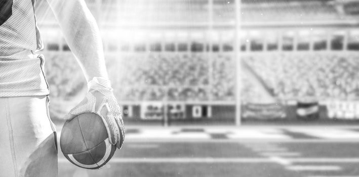 Closeup Portrait of a strong muscular American Football Player on big modern stadium field with lights and flares