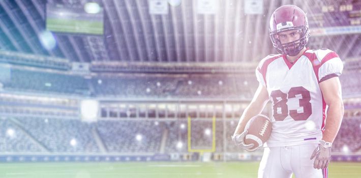 American Football Player isolated on big modern stadium field with lights and flares