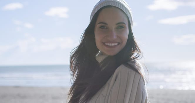 Portrait Of A Young Woman In Autumn Clothes Smiling On The Beach