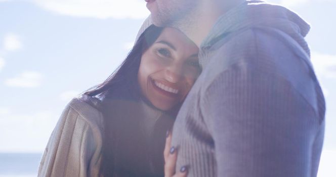 Cool Couple Laughing and hugging In Front Of Beach at beautiful autumn day