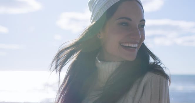 Portrait Of A Young Woman In Autumn Clothes Smiling On The Beach