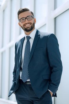 serious businessman standing in a spacious office.photo with text space