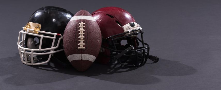 american football and helmets isolated on gray background