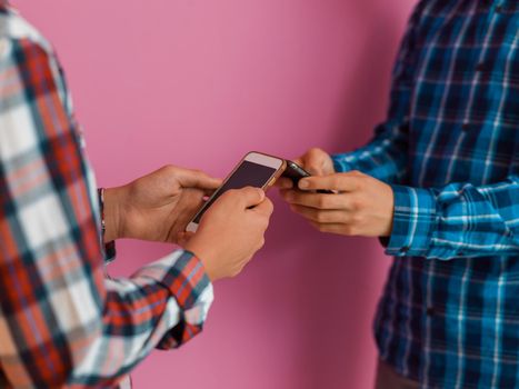 Arab teenagers group using smartphones for social media networking and sharing information for online education. Selective focus. High quality photo