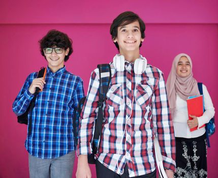 Arabic teenagers group, students team walking forward in future and back to school concept pink background