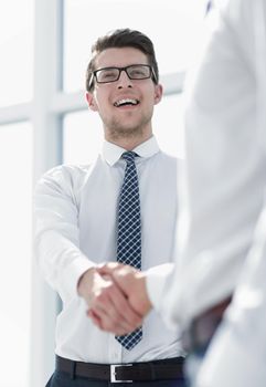 young businessman shakes hands with a business partner.business concept