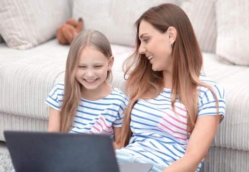 mother and daughter are watching their favorite TV show.people and technology