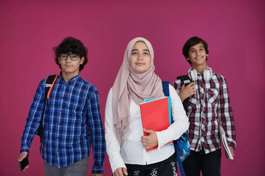 Arabic teenagers group, students team walking forward in future and back to school concept pink background