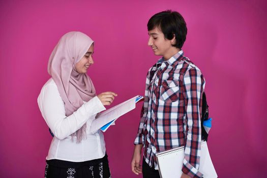 Arabic teenagers group, students team walking forward in future and back to school concept pink background