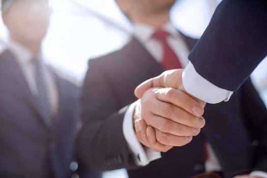 close up.handshake business partners.business background