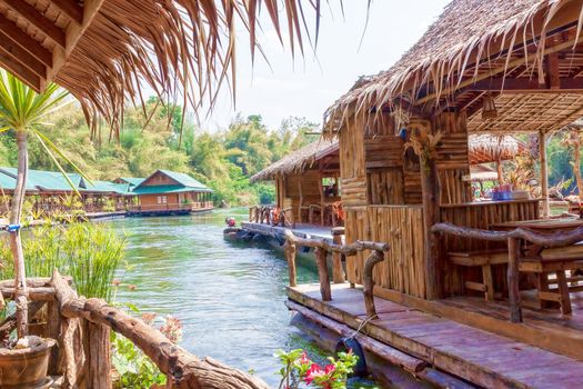 The concept of family tourism. Floating tourist huts on the river Kwai, Thailand.