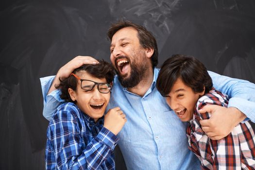 happy father hugging sons unforgettable moments of family joy in mixed race middle eastern Arab family. High quality photo