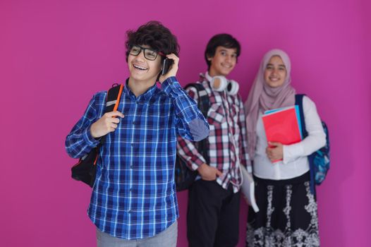 Arabic teenagers group, students team walking forward in future and back to school concept pink background