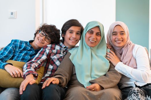 Middle eastern family portrait single mother with teenage kids at home in the living room. Selective focus . High quality photo