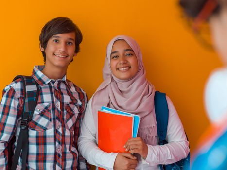 A group of Arab teenagers, a student team walking forward into the future and back to school the concept of a yellow background. The concept of successful education for young people. Selective focus. High quality photo