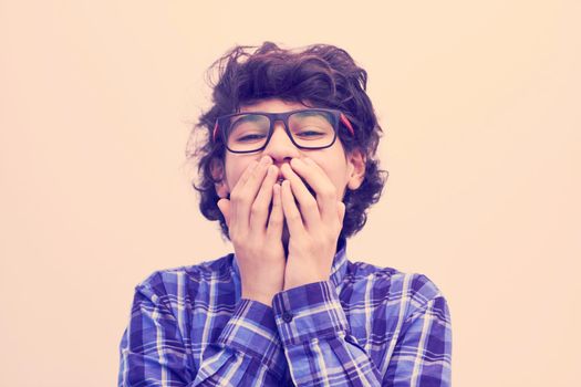 portrait  of smart looking arab teenager with glasses wearing a hat in casual school look isolated on white copy space