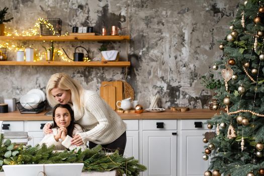 Mother and daughter in front of Christmas tree