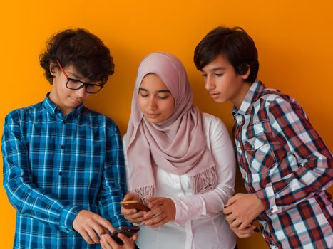 Arab teenagers group using smartphones for social media networking and sharing information for online education. High quality photo. Selective focus 