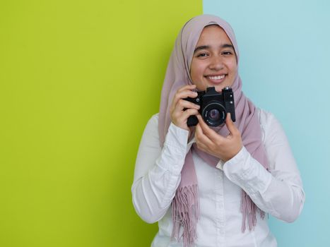 Portrait of Muslim woman photographer with slr camera.