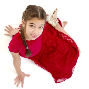 Portrait of a beautiful little girl looking from above. The concept of happy people, childhood. Isolated on white background. Close-up.