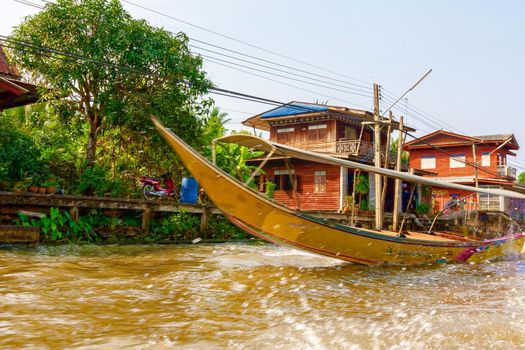 A long tourist boat floats on the River Kwai. Thailand. The concept of tourism, family vacation.