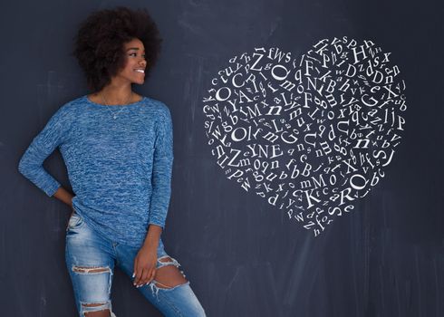 portrait of a beautiful friendly African American woman with a curly afro hairstyle and lovely smile isolated on a gray background