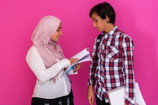 Arabic teenagers group, students team walking forward in future and back to school concept pink background. Selective focus. High quality photo