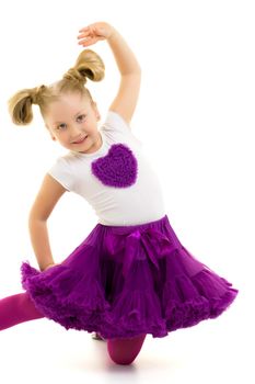 A sweet little gymnast girl performs an acrobatic element on the floor. The concept of sport, healthy lifestyle. Isolated on white background.