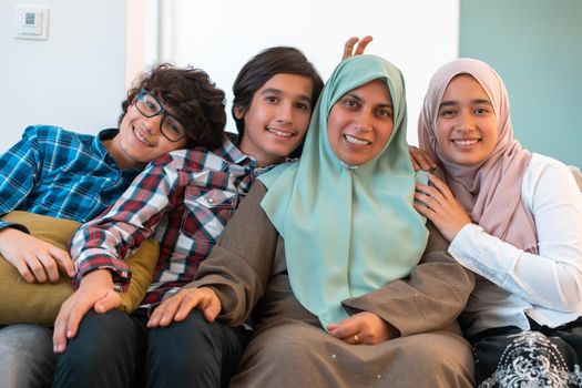 Middle eastern family portrait single mother with teenage kids at home in the living room. Selective focus . High quality photo