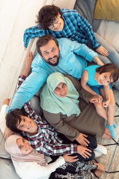 Top view photo of an Arab large family sitting in the living room of a modern house interior.Selective focus. High quality photo