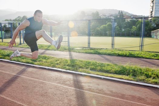 healthy young man at start line ready for run race and win