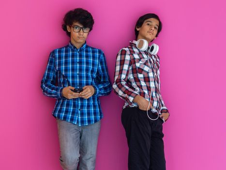 Arabic teenagers group portrait against a pink wall. High quality photo