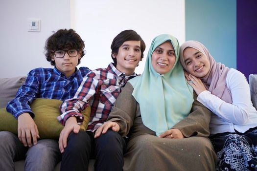 middle eastern family portrait single mother with teenage kids at home in living room