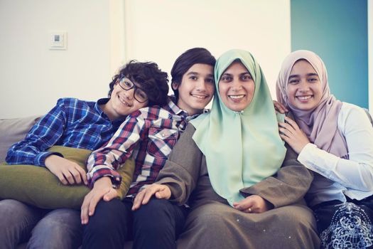middle eastern family portrait single mother with teenage kids at home in living room