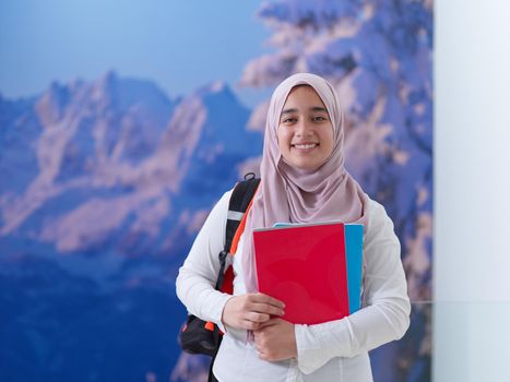 portrait of happy female middle eastern university student or teenager wearing casual islamic religious  look for school