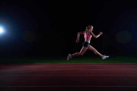Athletic woman running onrace  track